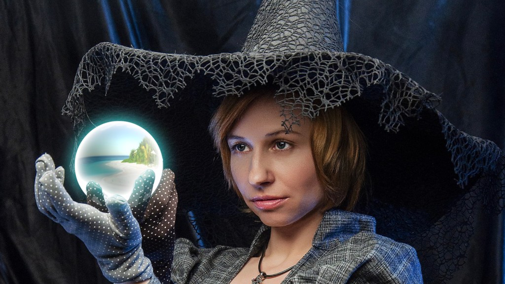 woman holding a crystal ball with an image of a beach inside
